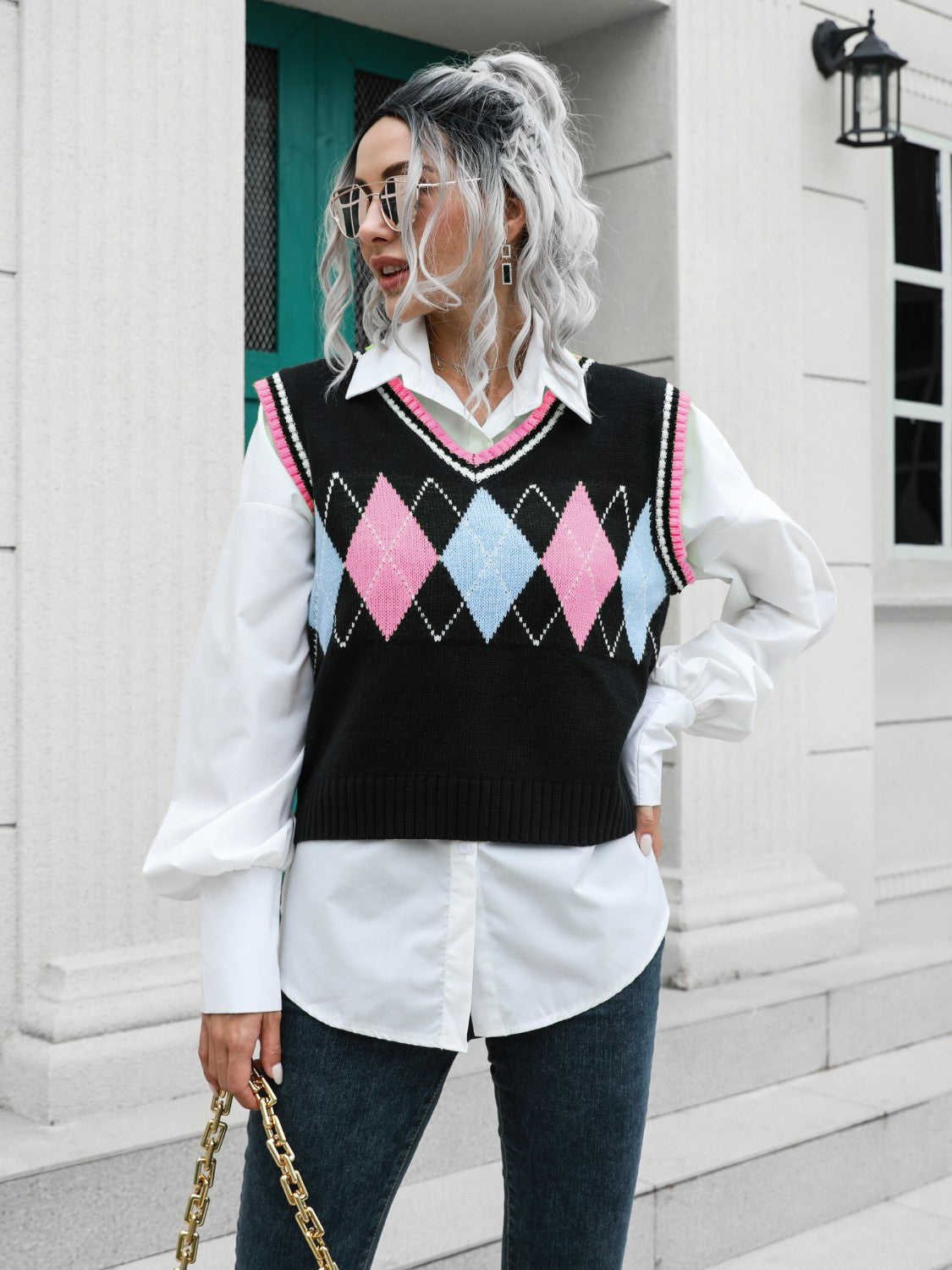 Argyle knit sweater vest with pink and blue diamonds and pink trim.