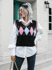 Argyle knit sweater vest with pink and blue diamonds and pink trim.