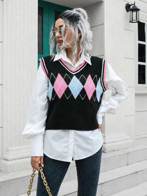 Argyle knit sweater vest with pink and blue diamonds and pink trim.