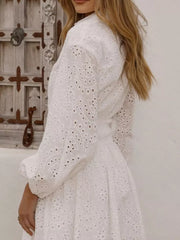 White eyelet balloon sleeve mini dress with detailed embroidery.
