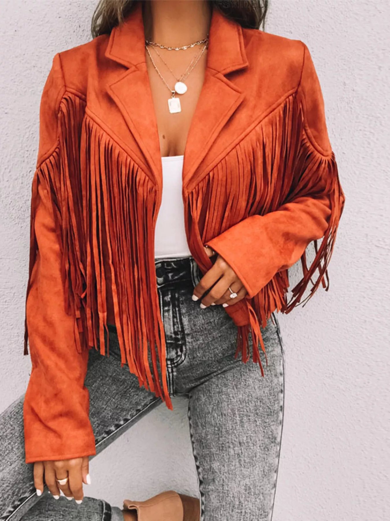 Orange cropped fringe jacket with lapels, open front, and long sleeves.