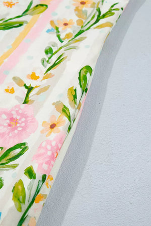 Floral print shift dress with pink and yellow flowers, green leaves, and striped accents.