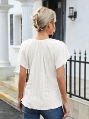 White eyelet blouse with flutter sleeves and tie neck detail