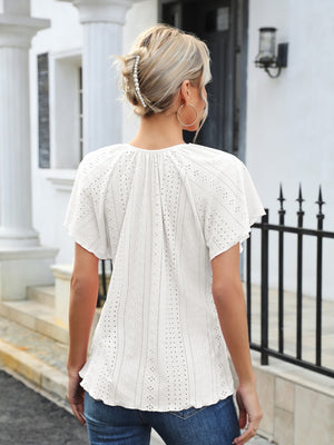 White eyelet blouse with flutter sleeves and tie neck detail