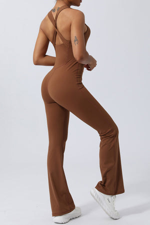 Brown cross-back flare leg unitard with a fitted silhouette and a subtle shimmer.