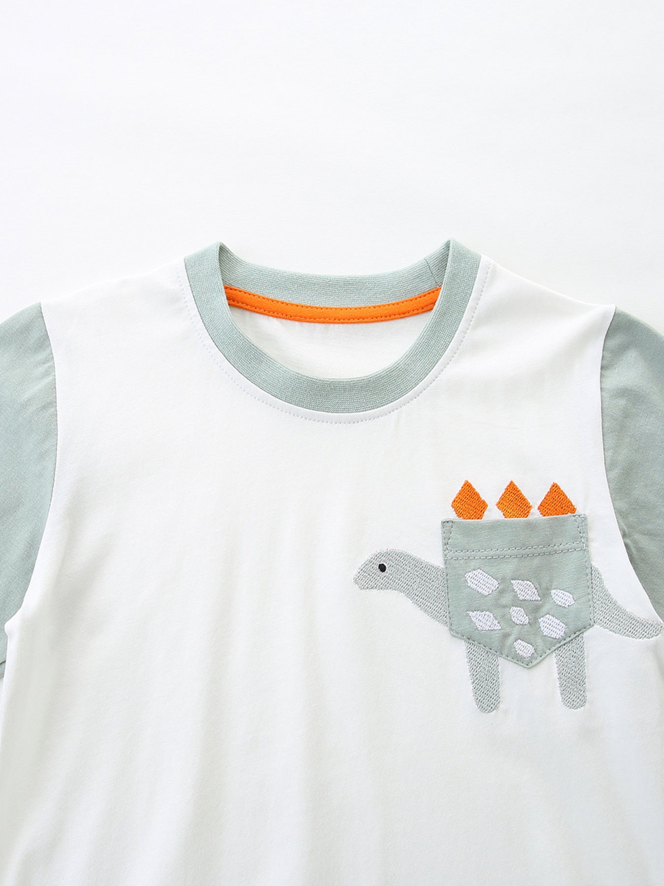Toddler boys' white cotton tee with dinosaur pocket and grey sleeves.