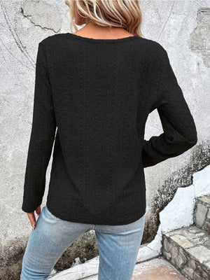 Black textured long sleeve henley top with a subtle eyelet pattern.