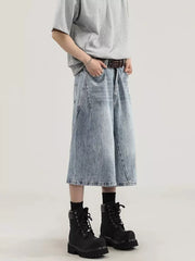 Light wash denim relaxed fit wide-leg capris with a distressed look, styled with a brown belt and black boots.