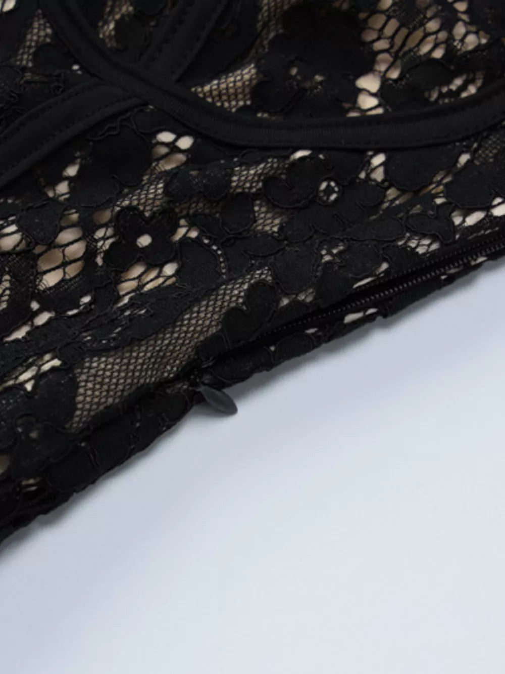 Black lace mini dress with spaghetti straps and a side zipper detail.