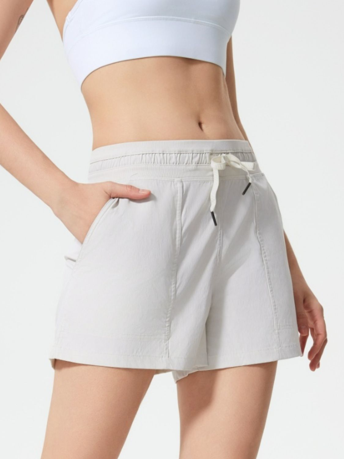Coastal drawstring utility shorts in light gray with pockets and elastic waistband.
