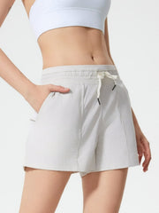 Coastal drawstring utility shorts in light gray with pockets and elastic waistband.