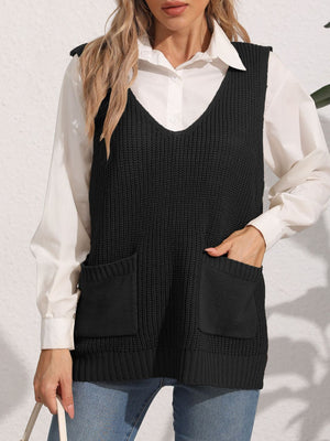 Black oversized knit vest with V-neck and patch pockets, styled over a white shirt.