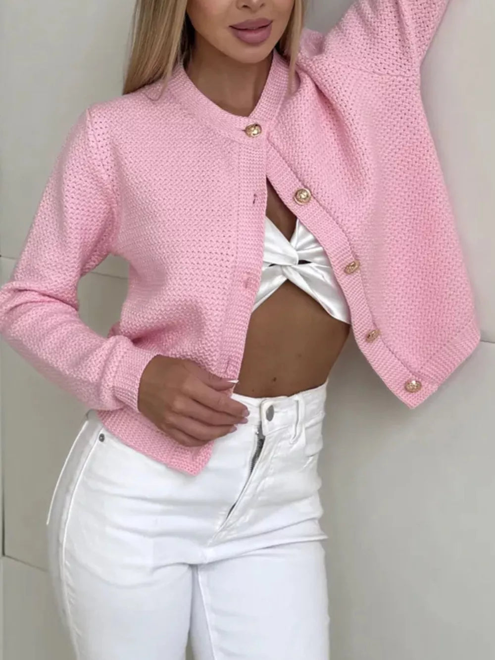 Textured knit cardigan in white with elegant button detail.