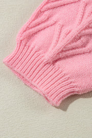 Blush pink knit sweater with cable knit detail and ribbed cuff.