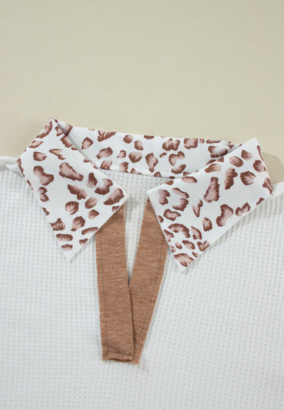 White waffle knit polo with leopard print collar detail and brown trim