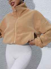 Tan fleece cropped jacket with funnel neck and zip closure.