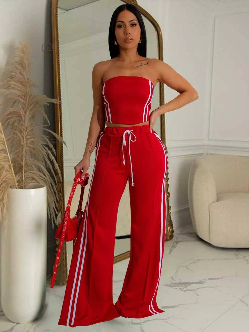 Red tube top and wide-leg pants set with white stripe details and drawstring waist.