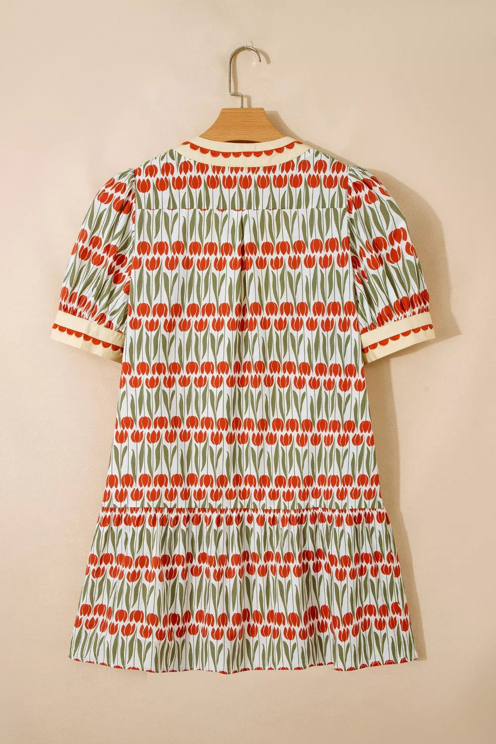 Cotton mini dress with red tulip print, short sleeves, and tiered skirt.