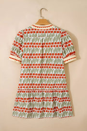 Cotton mini dress with red tulip print, short sleeves, and tiered skirt.