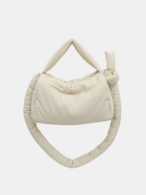Padded knot shoulder bag in beige with a knotted strap detail.