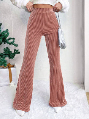 Textured corduroy bell bottom trousers in dusty pink, featuring a high waist and flared leg.