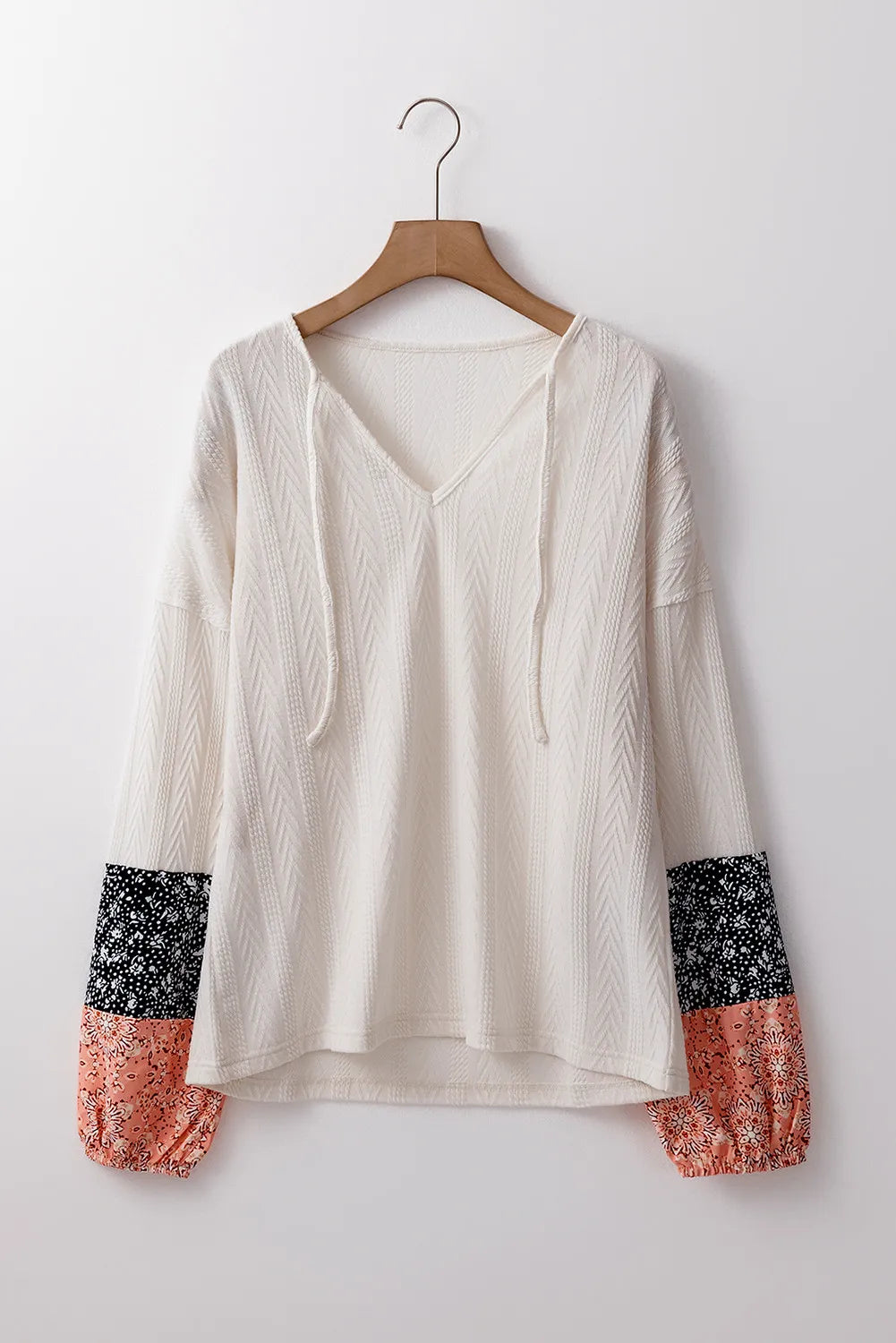 Textured sleeve blouse in cream with patterned cuffs and tie neck