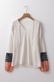 Textured sleeve blouse in cream with patterned cuffs and tie neck