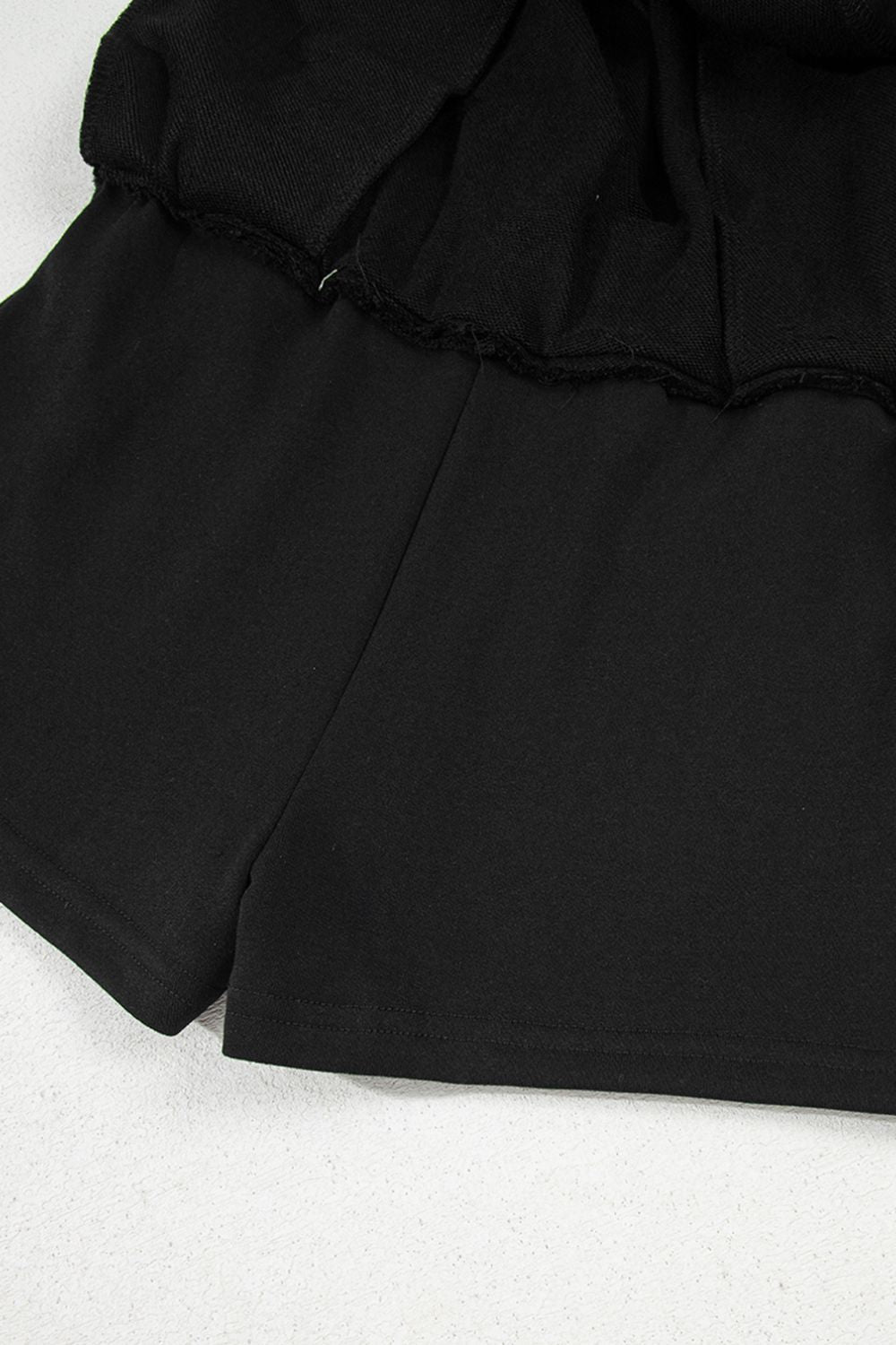 Black French terry skort with drawstring waist and pocket detail