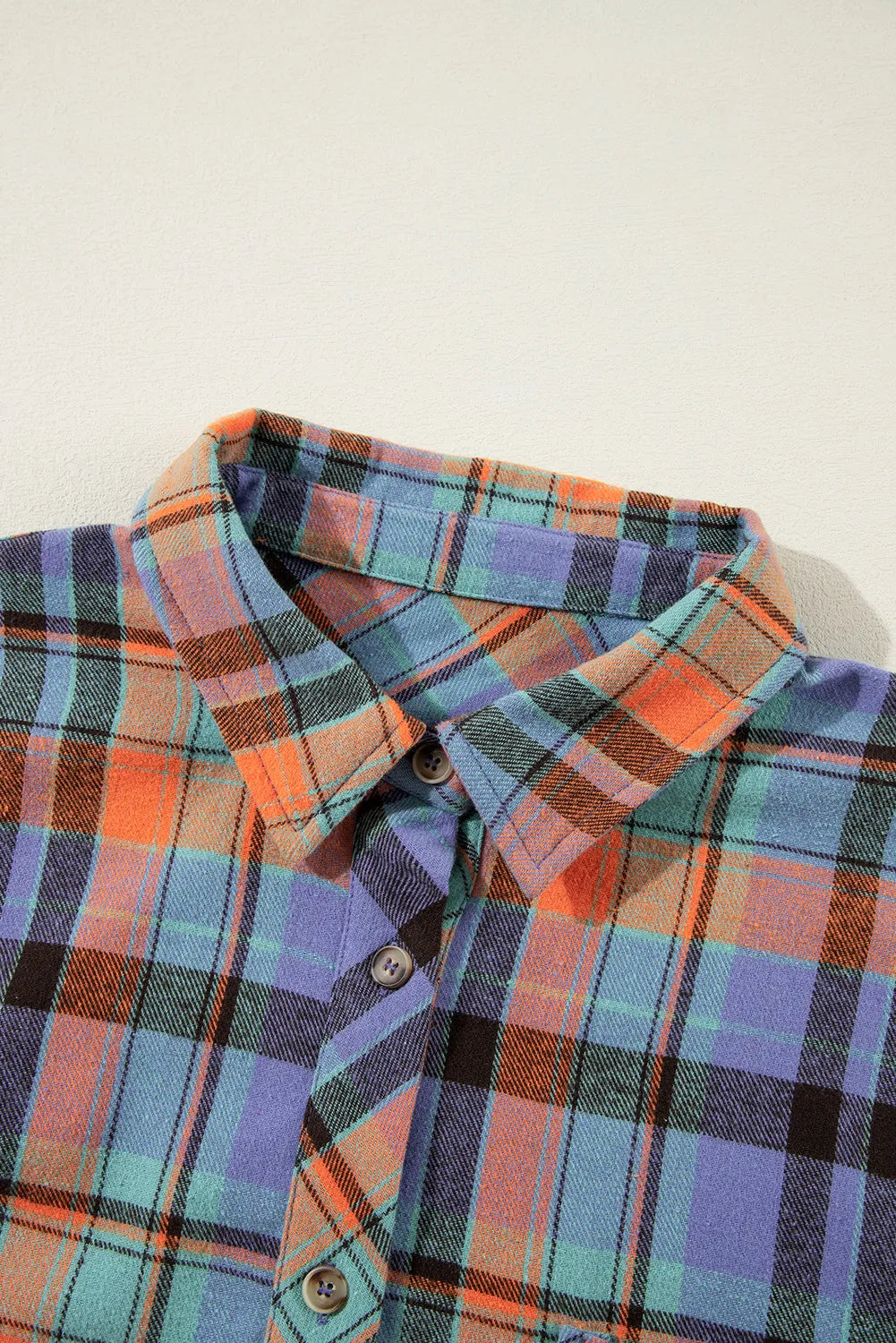 Oversized plaid shacket with button-down collar in orange and blue check.