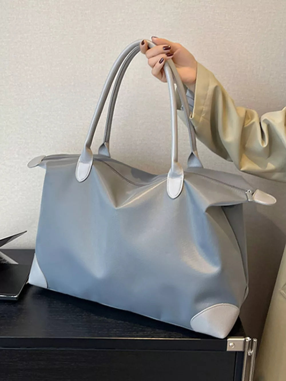 Grey Oxford cloth travel tote bag with light grey accents and double handles.