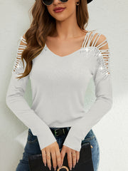 White ribbed knit blouse with cold shoulder cutouts and rhinestone embellishments.