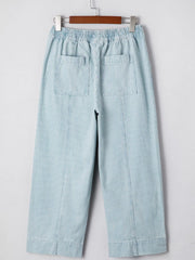Light blue striped cotton blend drawstring jeans with elastic waist and back pockets.
