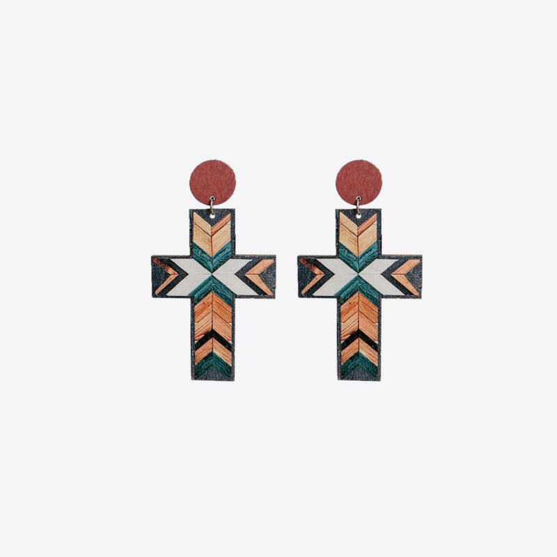 Geometric cross statement earrings with tribal pattern in beige, teal, and orange.