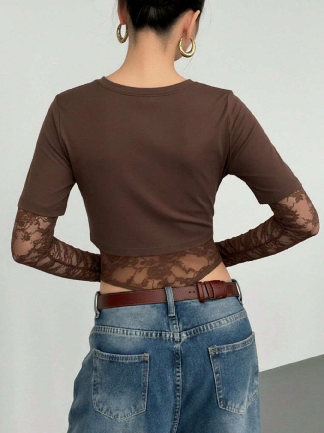 Brown lace bodysuit with sheer sleeves and lace trim detail.