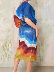 Denim asymmetrical top and slit skirt set with a rainbow chevron print and distressed details.