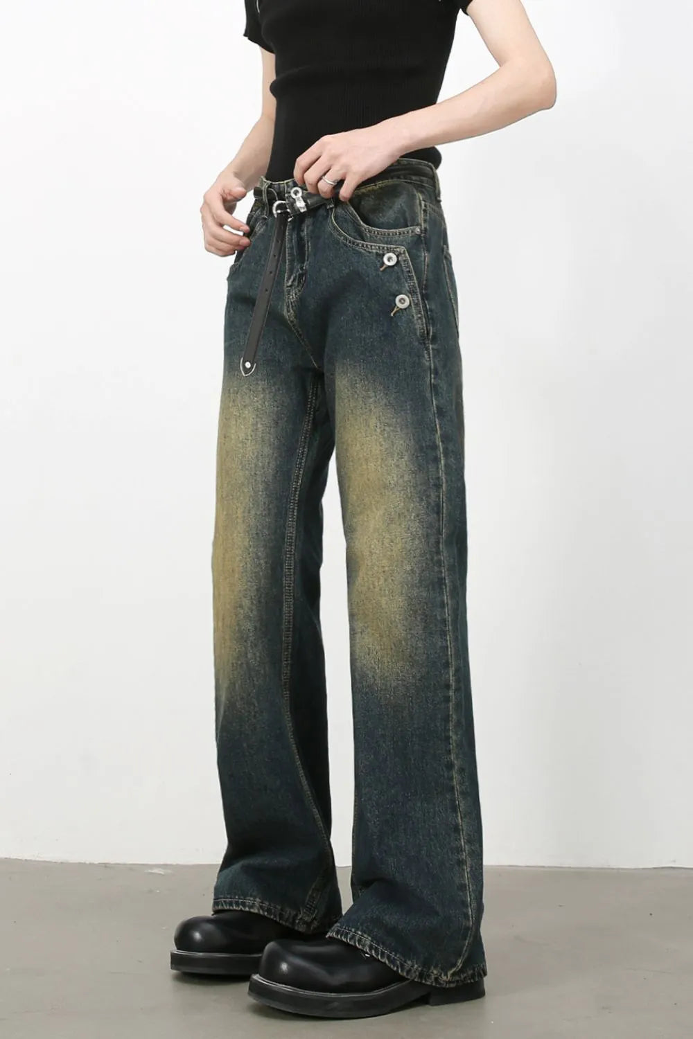 Dark wash bootcut jeans with faded details and button accents.