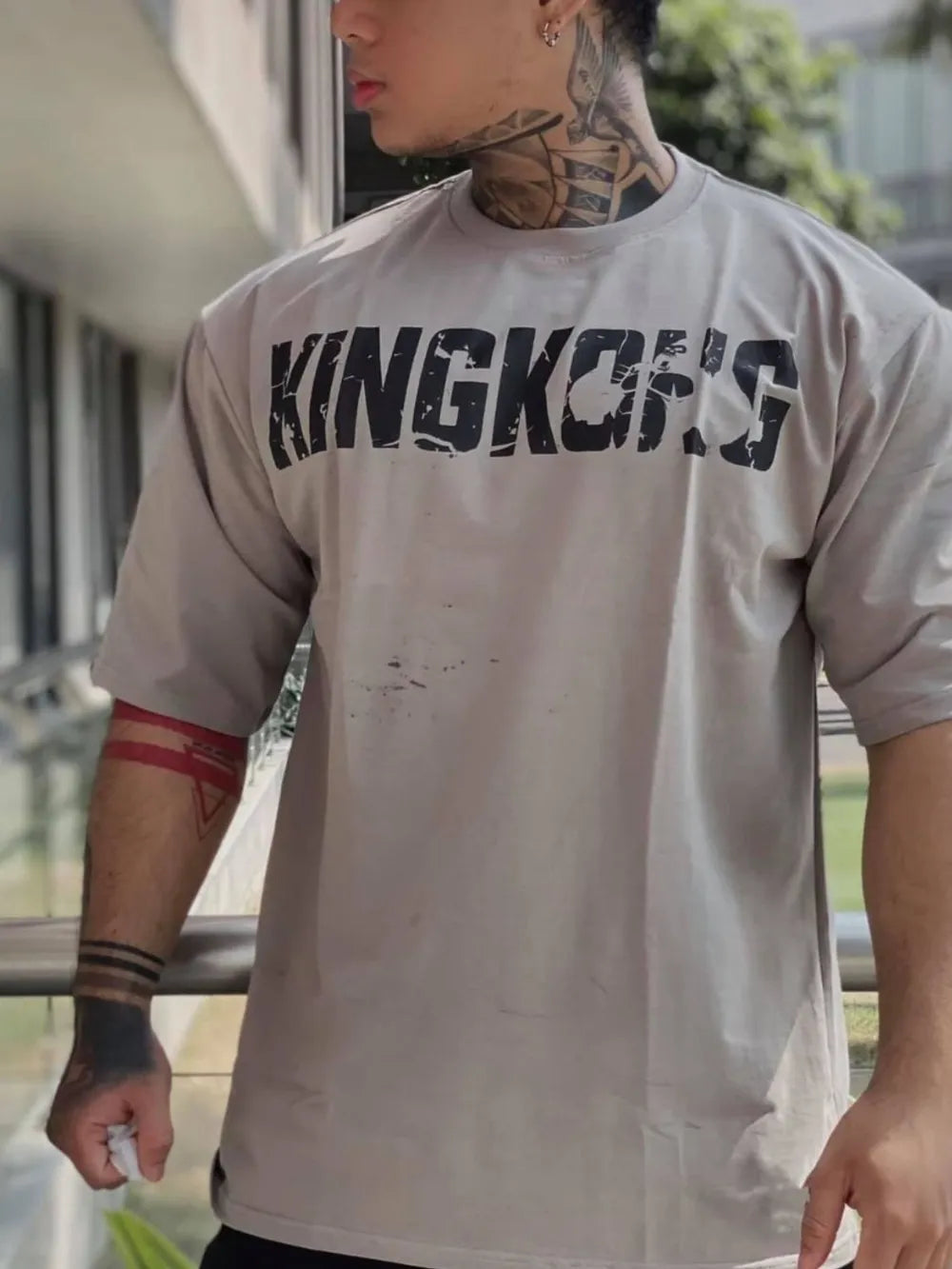 Gray oversized graphic tee with distressed King Kong's text and short sleeves.
