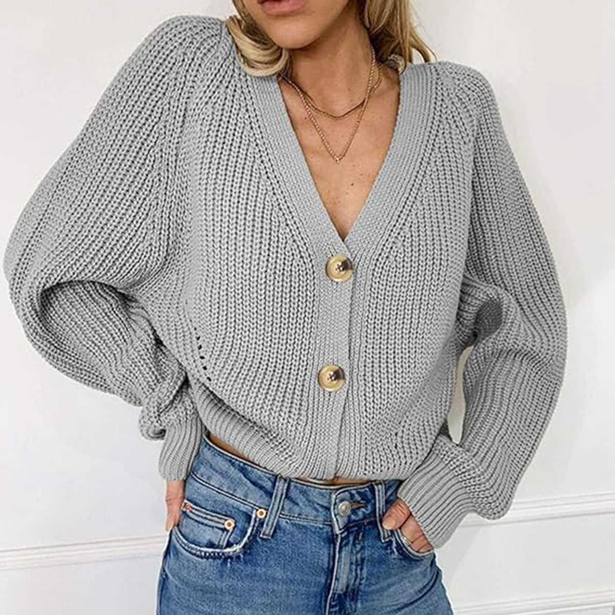 Gray ribbed knit cardigan with balloon sleeves and button front.