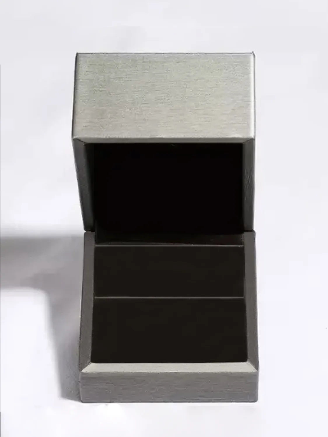 Silver jewelry box with open lid and dark interior