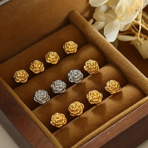 Sculpted rosebud stud earrings in gold and silver metal, chic floral design