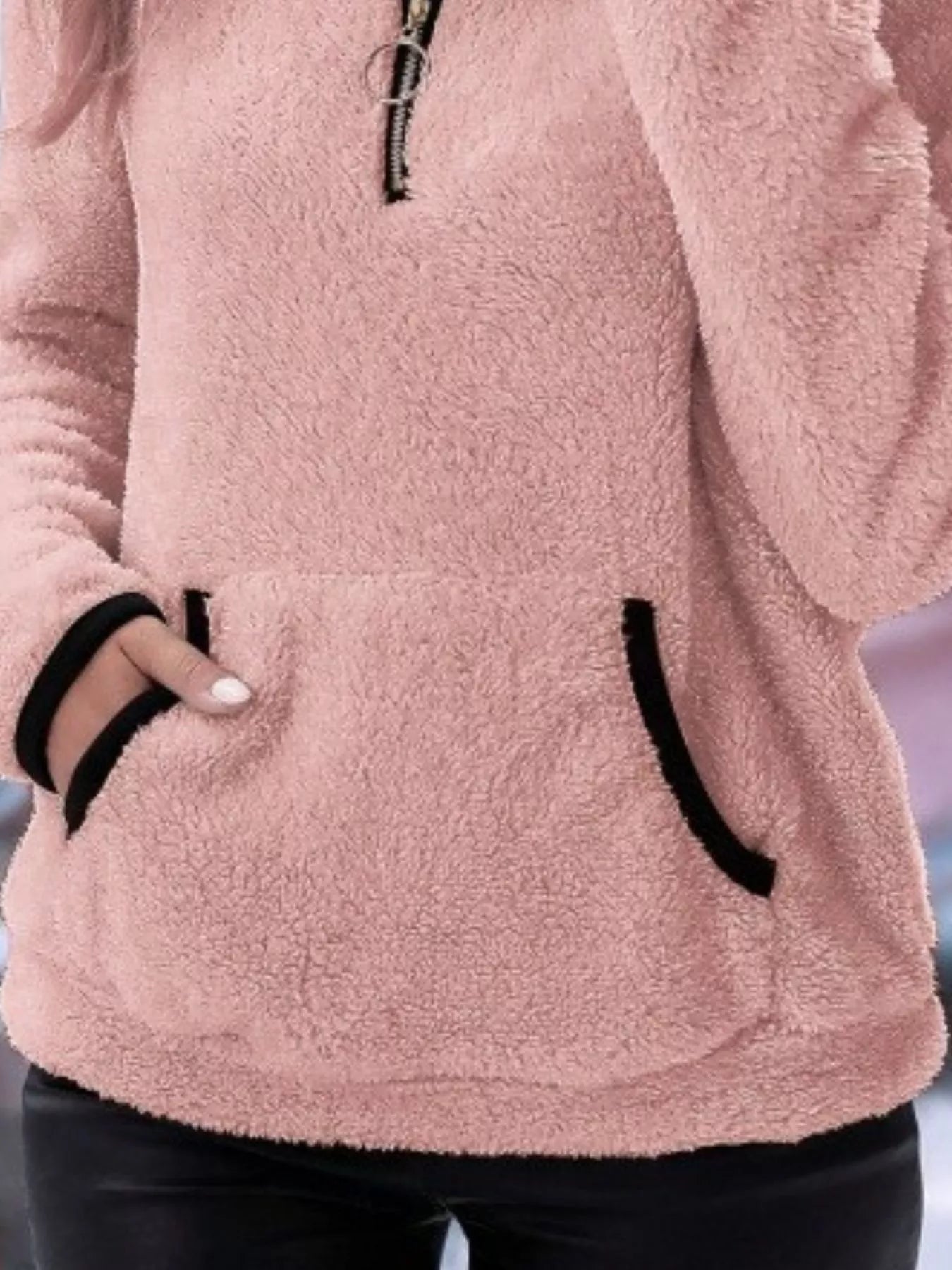 Pink fleece quarter zip pullover with black trim and front pocket.