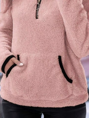 Pink fleece quarter zip pullover with black trim and front pocket.