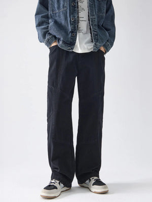 Black cotton wide-leg trousers with panel detailing and a relaxed fit.