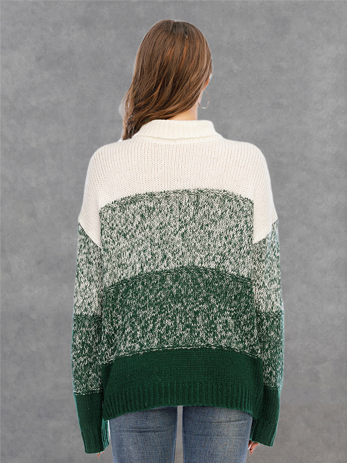 Colorblock turtleneck sweater in green and white acrylic with defined panels.