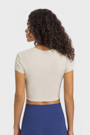 Ivory ribbed crewneck crop top with short sleeves.