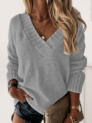 Grey knit sweater with ribbed trim V-neck and cuffs.