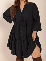 Black plus-size balloon sleeve dress with button front and tiered skirt.