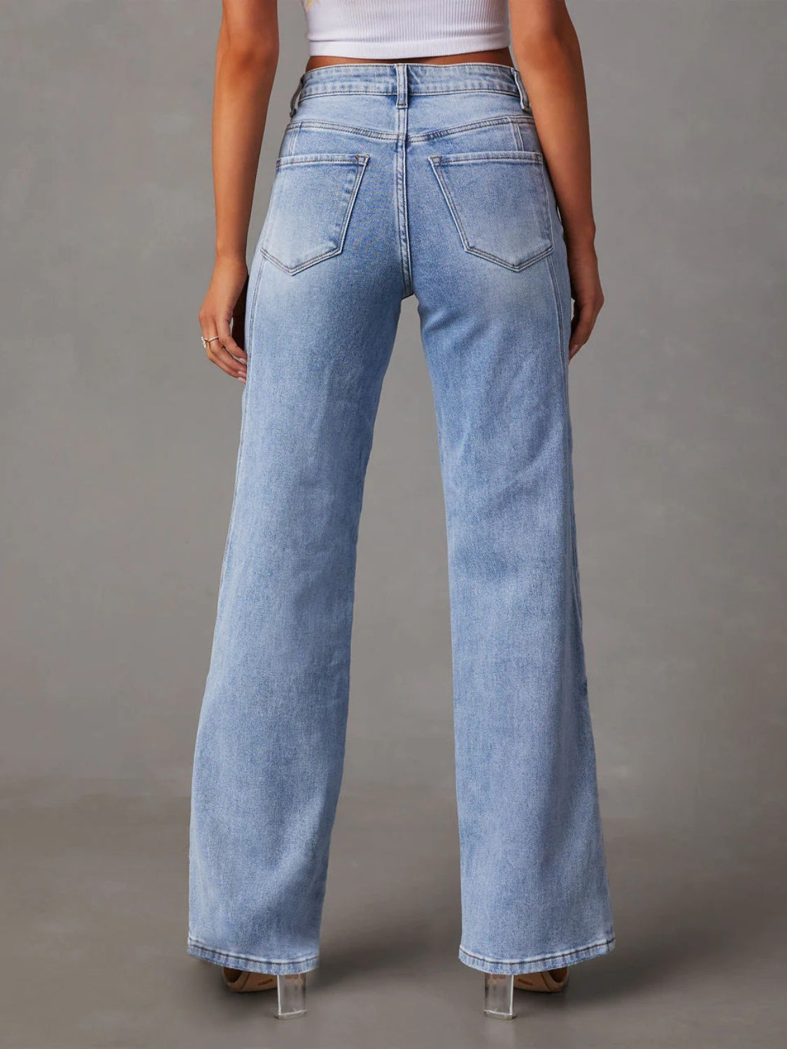 Panel seam wide leg jeans in light wash denim with a high rise and flared hem.