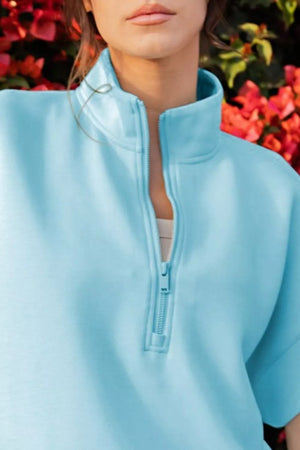 Aqua half-zip pajama top with a stand-up collar and visible zipper detail.