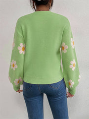Mid Green knit sweater with puff sleeves and a daisy floral print.